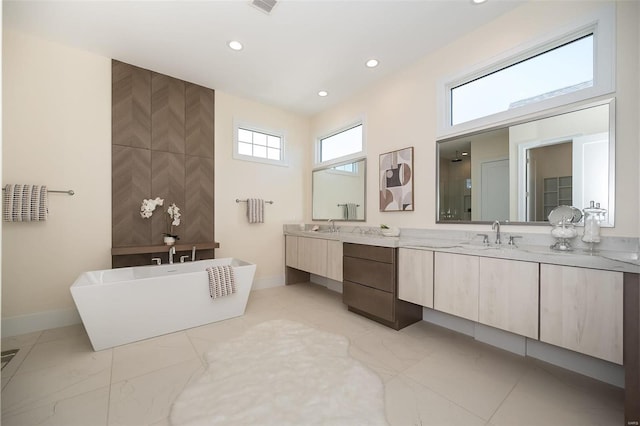 full bath featuring baseboards, a soaking tub, recessed lighting, vanity, and a walk in shower