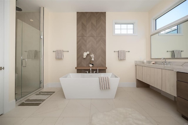 bathroom with marble look tile flooring, a stall shower, baseboards, and vanity