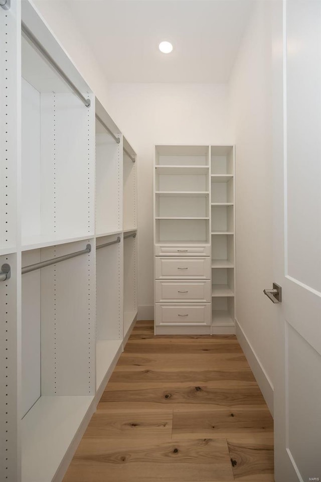 spacious closet featuring light wood-style flooring