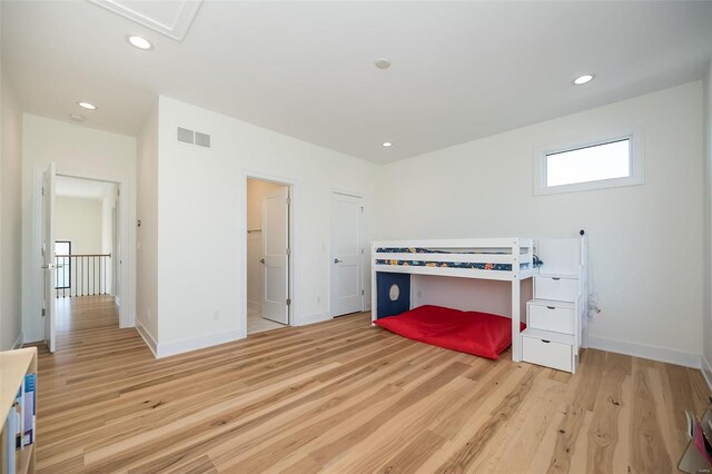 unfurnished bedroom featuring light wood-style flooring, baseboards, and recessed lighting