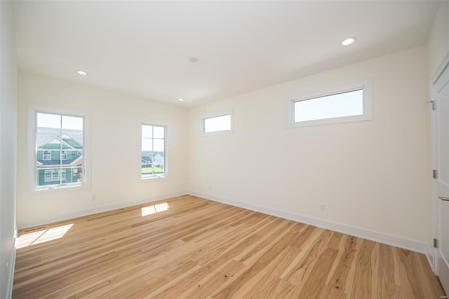 unfurnished room featuring light wood-style floors, baseboards, and recessed lighting
