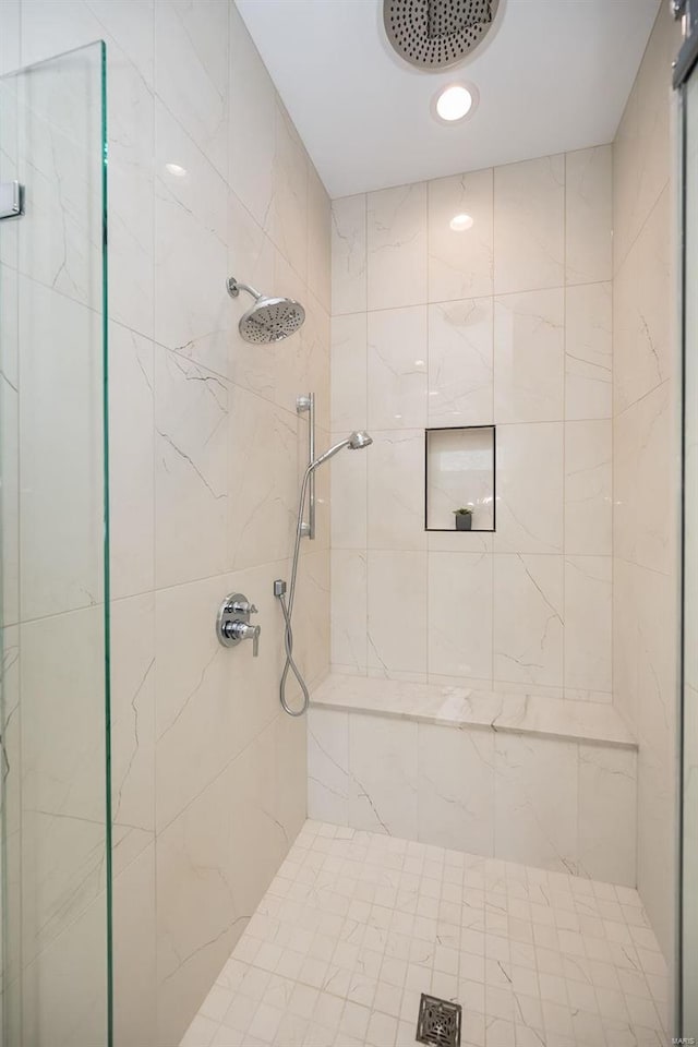 full bath featuring a tile shower