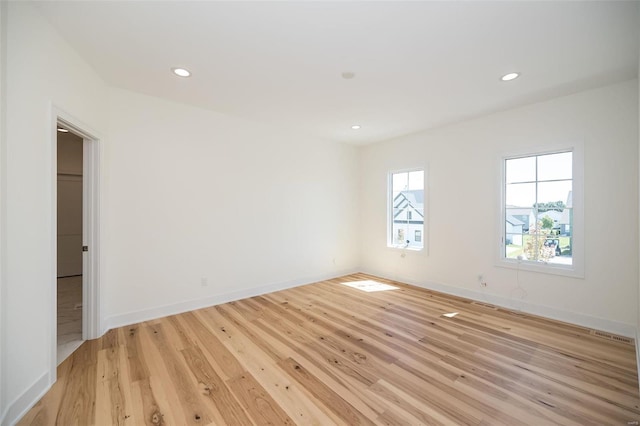 unfurnished room featuring light wood-style floors, recessed lighting, and baseboards