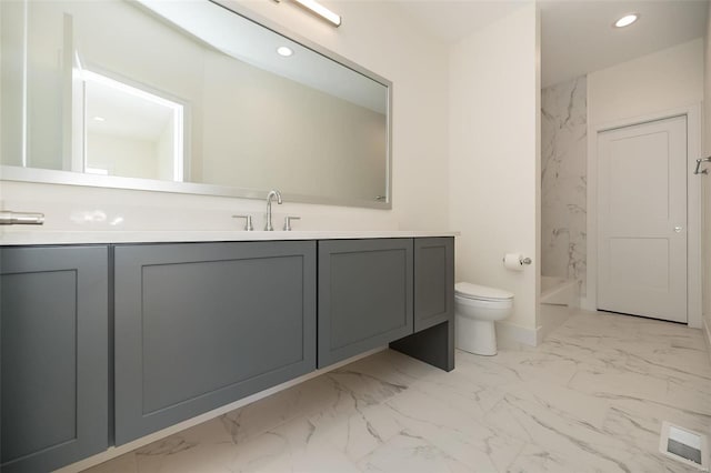 bathroom with marble look tiles, toilet, vanity, and recessed lighting