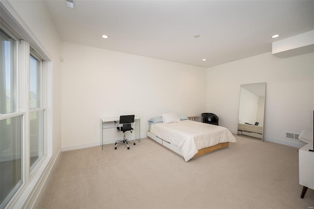 bedroom with light carpet, recessed lighting, an office area, and baseboards