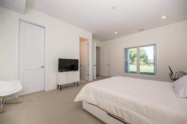 bedroom featuring light colored carpet and recessed lighting