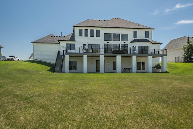 rear view of house featuring stairs, a lawn, a deck, and a shingled roof