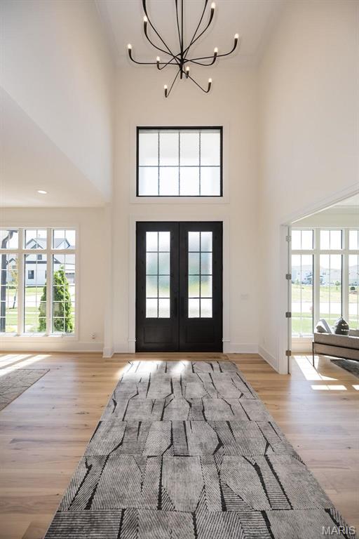 1205 Patchwork Flds, Chesterfield, MO 63005 - foyer with a chandelier, french doors, a towering ceiling, healthy amount of natural light, and light wood-type flooring