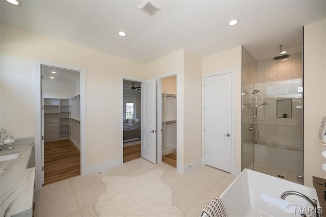 1205 Patchwork Flds, Chesterfield, MO 63005 - bathroom featuring a shower stall, marble look tiles, recessed lighting, baseboards, and a spacious closet