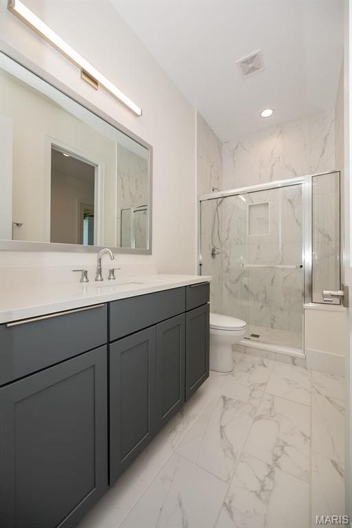 1205 Patchwork Flds, Chesterfield, MO 63005 - bathroom featuring a marble finish shower, marble look tile flooring, toilet, vanity, and recessed lighting
