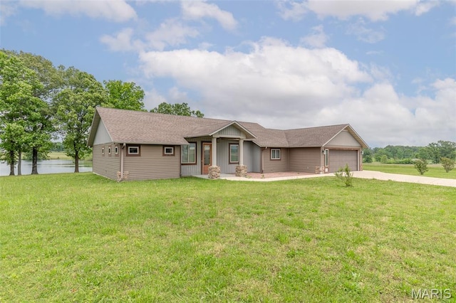 232 Confederate Ridge Rd, Doniphan, MO 63935 - ranch-style home with concrete driveway, an attached garage, a front lawn, and a water view