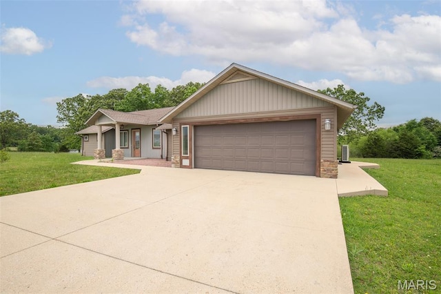 232 Confederate Ridge Rd, Doniphan, MO 63935 - view of front of home featuring a front lawn, a garage, concrete driveway, and stone siding