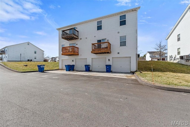 638 Homerun Dr Unit 36N, Ofallon, MO 63366 - back of house with a balcony, a garage, and a lawn