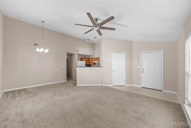 638 Homerun Dr Unit 36N, Ofallon, MO 63366 - unfurnished living room with ceiling fan, a chandelier, light carpet, high vaulted ceiling, and baseboards