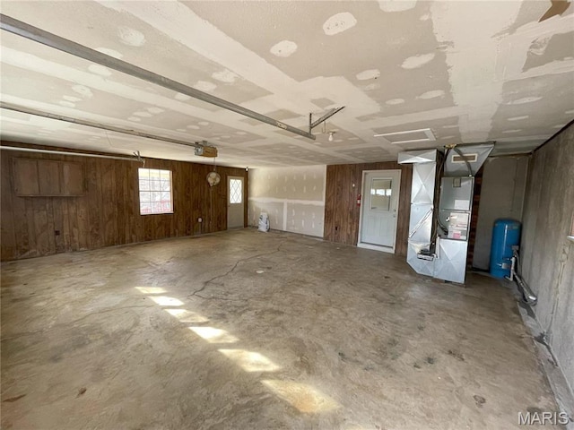 1770 Pigg Hollow Rd, Owensville, MO 65066 - garage with a garage door opener, heating unit, and wood walls
