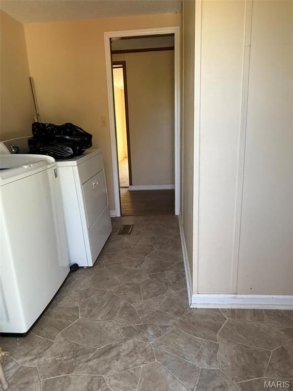 434 Whispering Wind Ln, Cape Girardeau, MO 63701 - laundry room with washer and dryer and baseboards