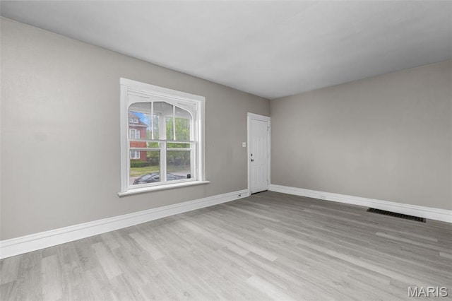 6040 Maple Ave, Saint Louis, MO 63112 - spare room featuring wood finished floors and baseboards