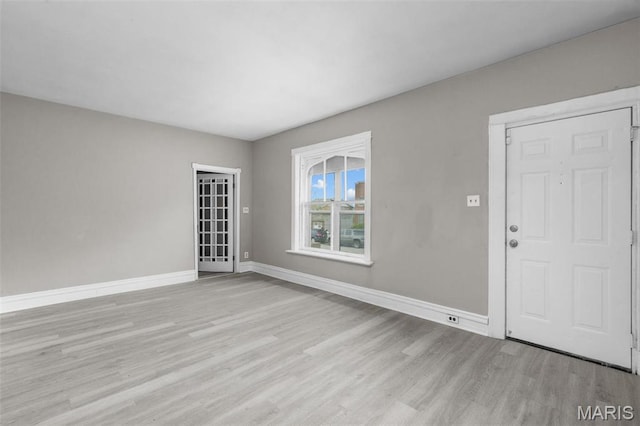 6040 Maple Ave, Saint Louis, MO 63112 - unfurnished living room with light wood finished floors and baseboards