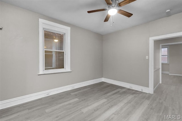 6040 Maple Ave, Saint Louis, MO 63112 - unfurnished room with wood finished floors, a ceiling fan, and baseboards