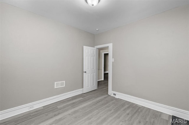 6040 Maple Ave, Saint Louis, MO 63112 - spare room with wood finished floors and baseboards