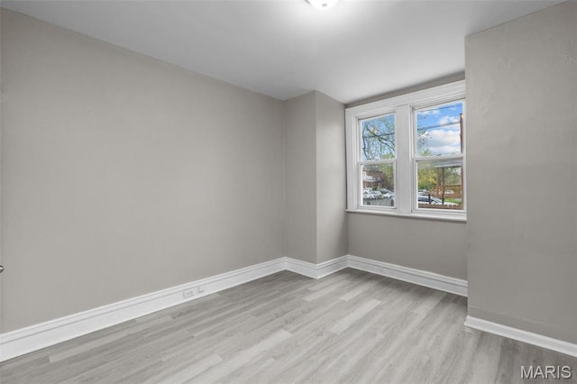 6040 Maple Ave, Saint Louis, MO 63112 - spare room with wood finished floors and baseboards