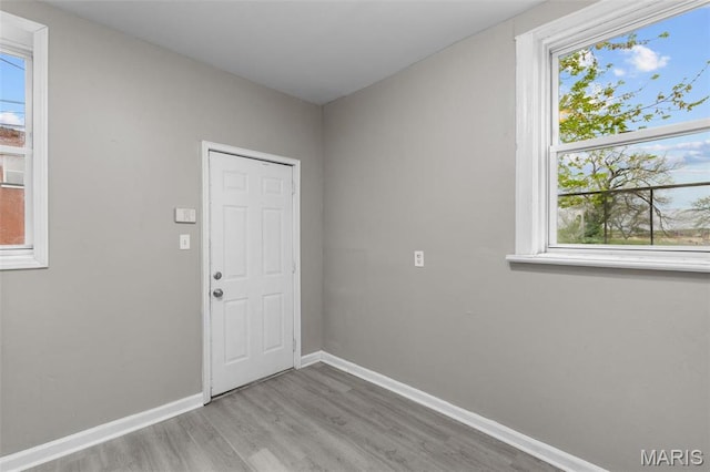 6040 Maple Ave, Saint Louis, MO 63112 - doorway with wood finished floors, healthy amount of natural light, and baseboards