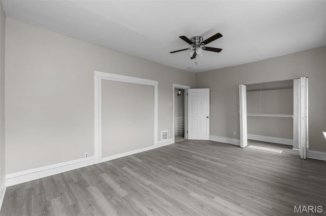 6040 Maple Ave, Saint Louis, MO 63112 - unfurnished bedroom with wood finished floors, baseboards, and a closet