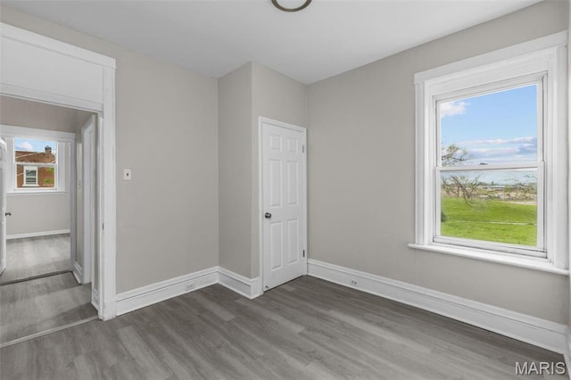 6040 Maple Ave, Saint Louis, MO 63112 - empty room featuring wood finished floors and baseboards