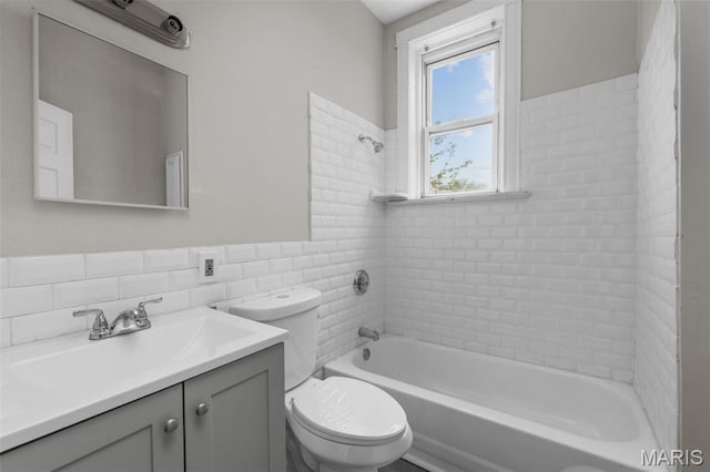 6040 Maple Ave, Saint Louis, MO 63112 - bathroom featuring tile walls, bathtub / shower combination, toilet, vanity, and wainscoting