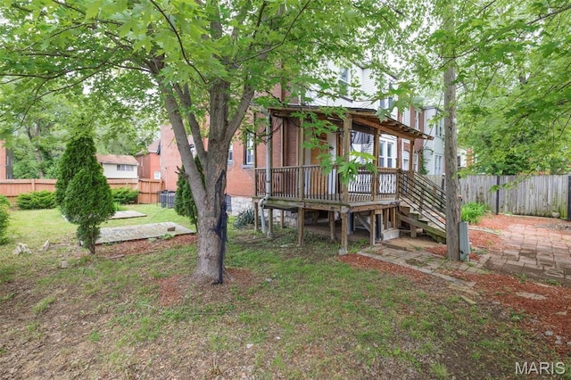 6040 Maple Ave, Saint Louis, MO 63112 - rear view of house with a wooden deck and stairway