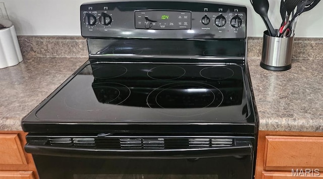 3605 Tracey Rich Unit 2B, Lemay Township, MO 63125 - kitchen view of black / electric stove and brown cabinetry