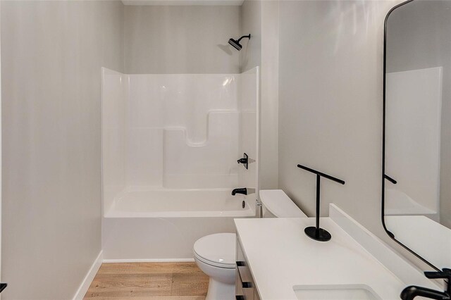 115 S Taylor St, Red Bud, IL 62278 - bathroom featuring toilet, wood finished floors, vanity, shower / tub combination, and baseboards