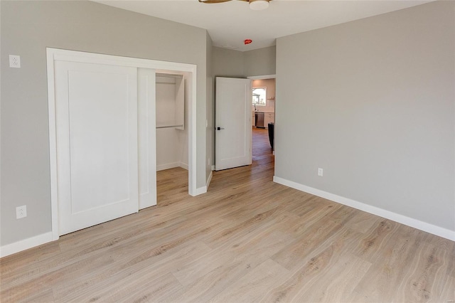 115 S Taylor St, Red Bud, IL 62278 - unfurnished bedroom with baseboards, wood finished floors, and a closet