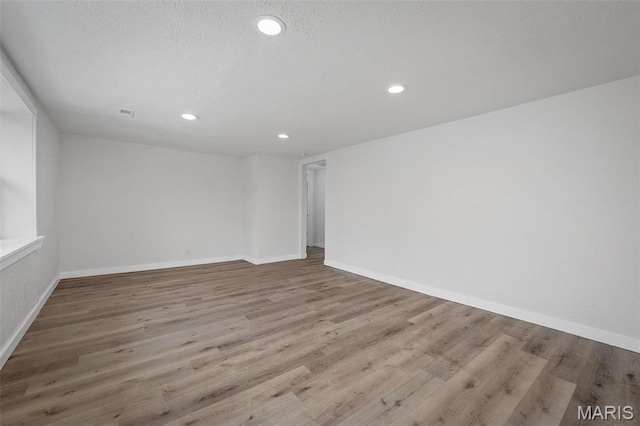 700 W Main St, Union, MO 63084 - empty room with recessed lighting, wood finished floors, baseboards, and a textured ceiling
