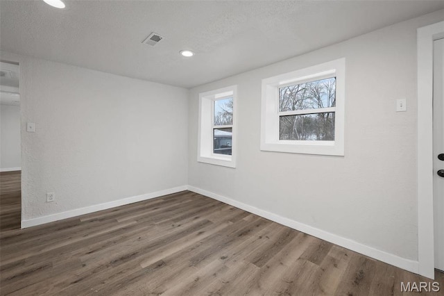 700 W Main St, Union, MO 63084 - empty room featuring baseboards, wood finished floors, a textured ceiling, and recessed lighting