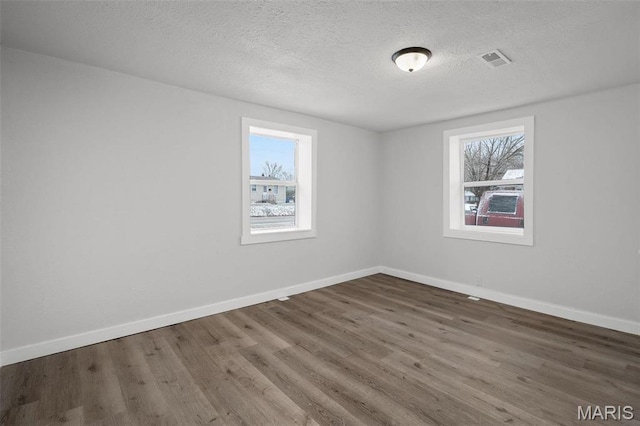 700 W Main St, Union, MO 63084 - unfurnished room with wood finished floors, baseboards, and a textured ceiling