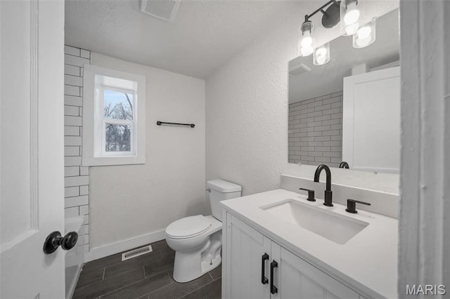700 W Main St, Union, MO 63084 - full bath with toilet, wood tiled floors, vanity, baseboards, and a textured ceiling