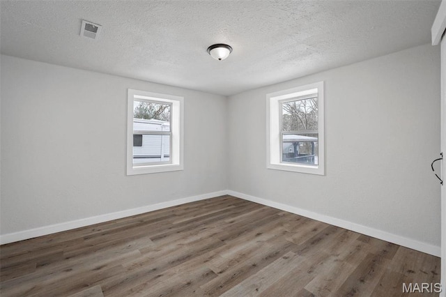 700 W Main St, Union, MO 63084 - empty room featuring wood finished floors, baseboards, and a textured ceiling