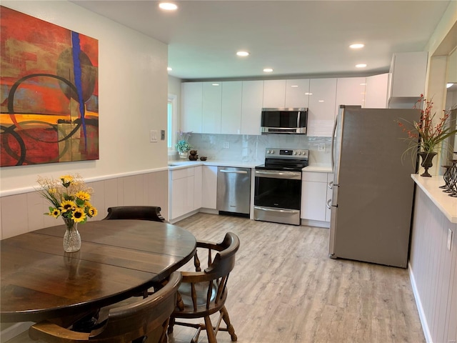 2903 Lesmer Ct, Overland, MO 63114 - kitchen with appliances with stainless steel finishes, modern cabinets, white cabinetry, and recessed lighting