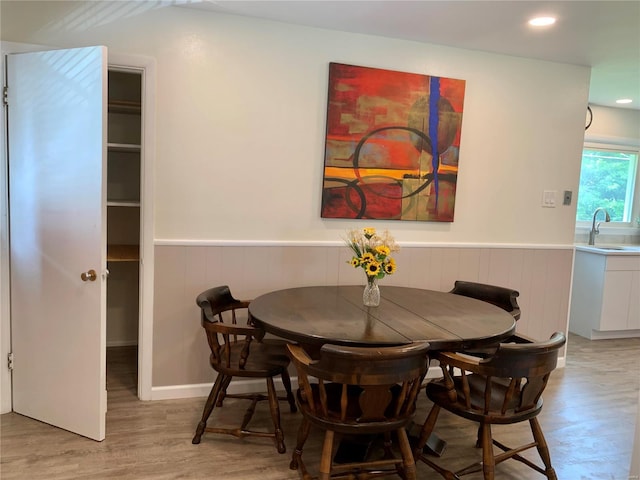 2903 Lesmer Ct, Overland, MO 63114 - dining space with light wood-style floors, a wainscoted wall, and recessed lighting