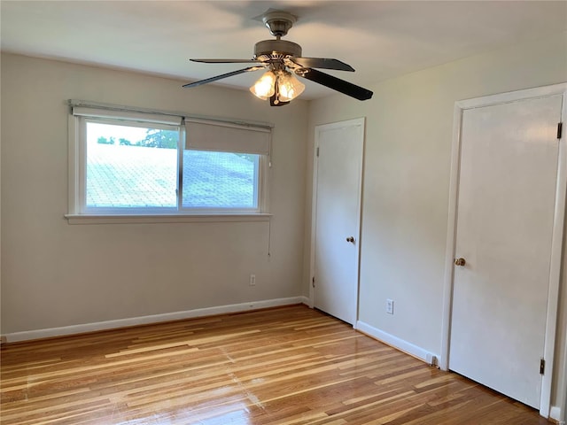 2903 Lesmer Ct, Overland, MO 63114 - unfurnished bedroom with light wood finished floors, baseboards, and ceiling fan