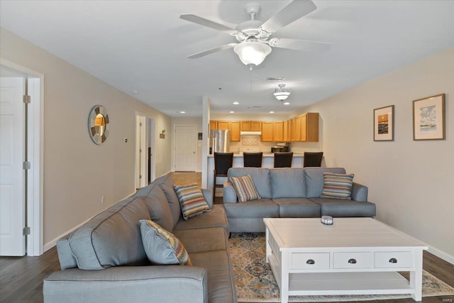 living area with dark wood finished floors, baseboards, ceiling fan, and recessed lighting