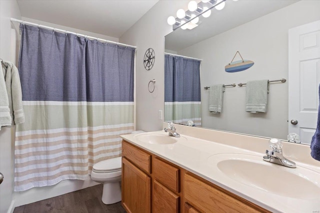 bathroom with wood finished floors, double vanity, toilet, and shower / bath combo with shower curtain