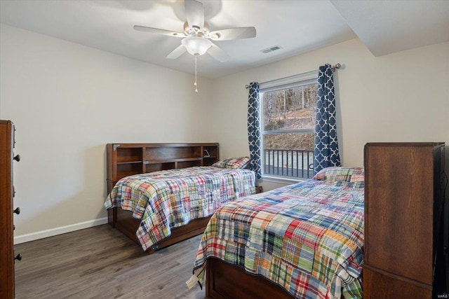 bedroom featuring wood finished floors, baseboards, and ceiling fan