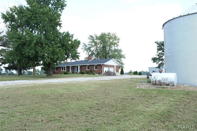 462 Il Route 127, Greenville, IL 62246 - view of front of home with brick siding, a front lawn, a garage, and a chimney