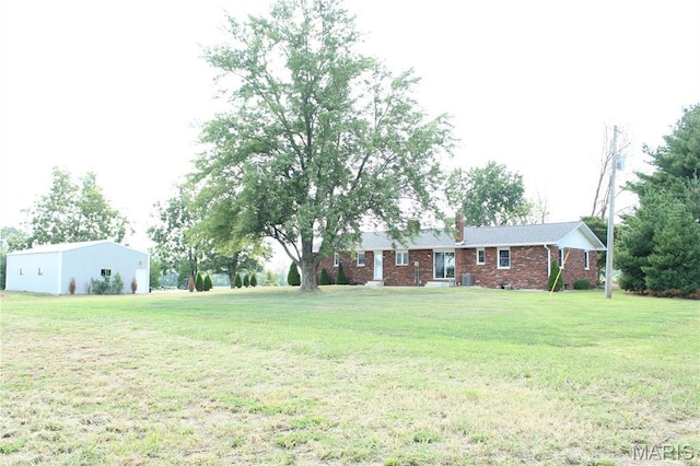 462 Il Route 127, Greenville, IL 62246 - view of front of house with brick siding, a front lawn, central AC unit, and a chimney