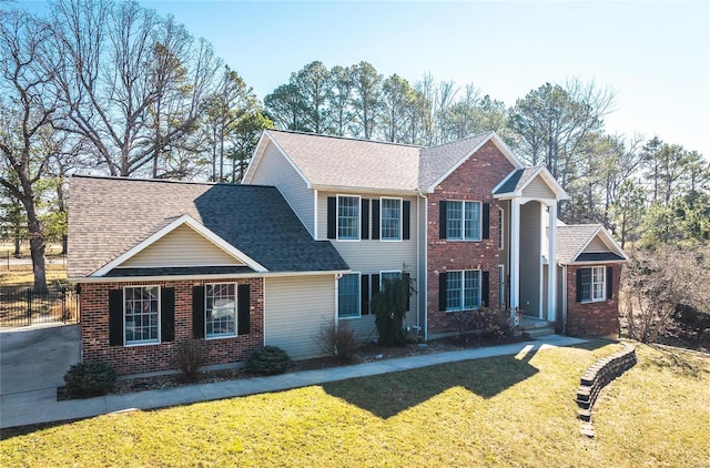view of front of property featuring brick siding and a shingled roof