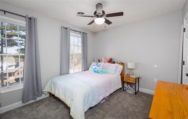 bedroom with carpet flooring, baseboards, a ceiling fan, and a textured ceiling