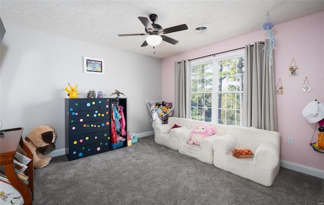 bedroom featuring carpet floors, a textured ceiling, ceiling fan, and baseboards