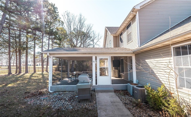 view of yard with a sunroom and central air condition unit